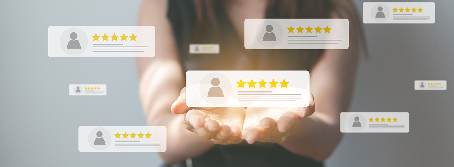 The image shows a hand holding a tablet with a star rating graphic on the screen, indicating high customer satisfaction or approval.