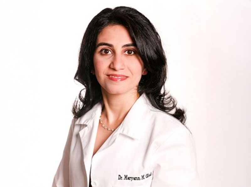 The image depicts a modern office reception area with a sleek, contemporary design featuring a wooden desk and a white countertop.